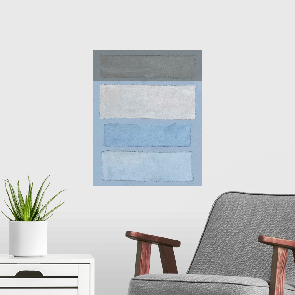 A modern room featuring Mixed media art with blue and gray linen rectangles placed horizontally on a vertical canvas with...