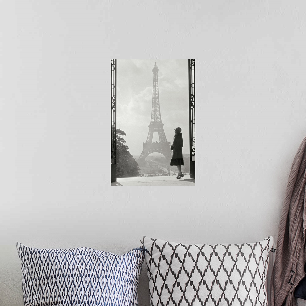 A bohemian room featuring Vintage photograph of a stylish woman standing in an art deco gateway with the Eiffel Tower in th...