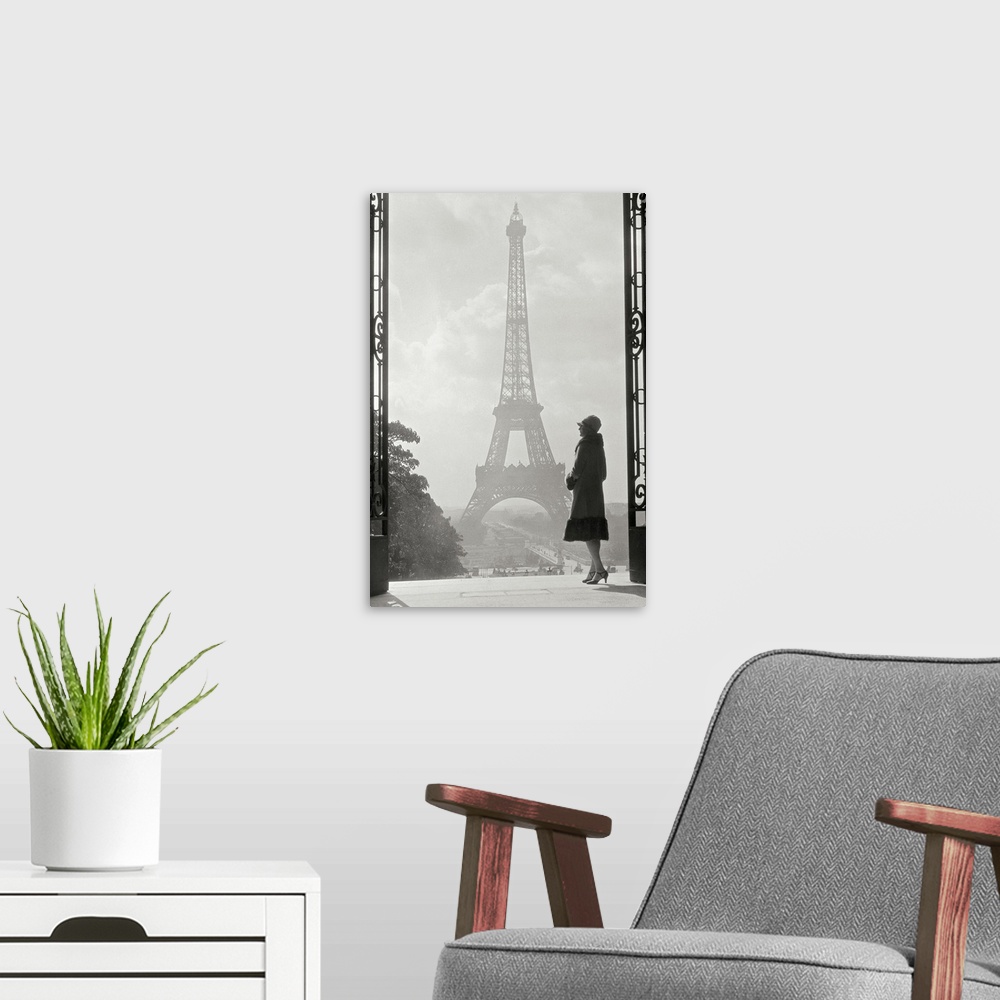 A modern room featuring Vintage photograph of a stylish woman standing in an art deco gateway with the Eiffel Tower in th...