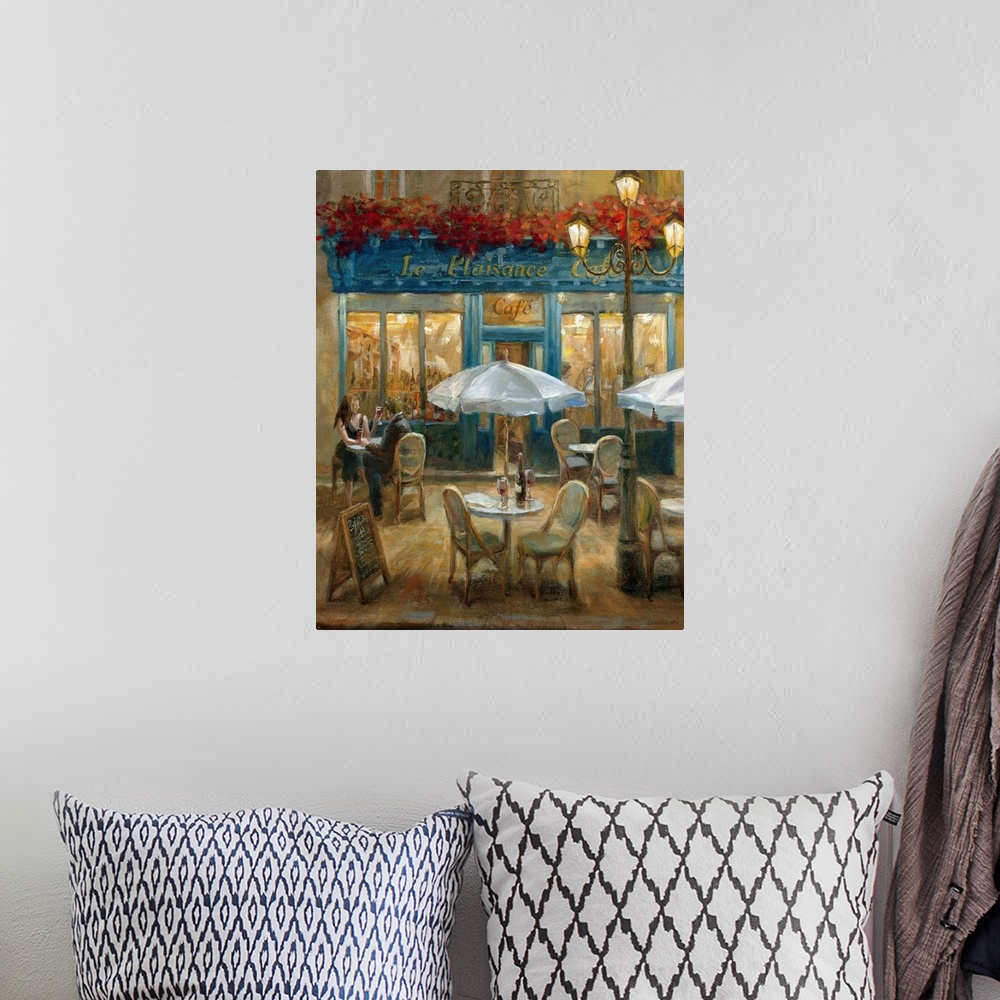 A bohemian room featuring Painting of tables and chairs outside of a street cafo at night with flowerbox over front door en...