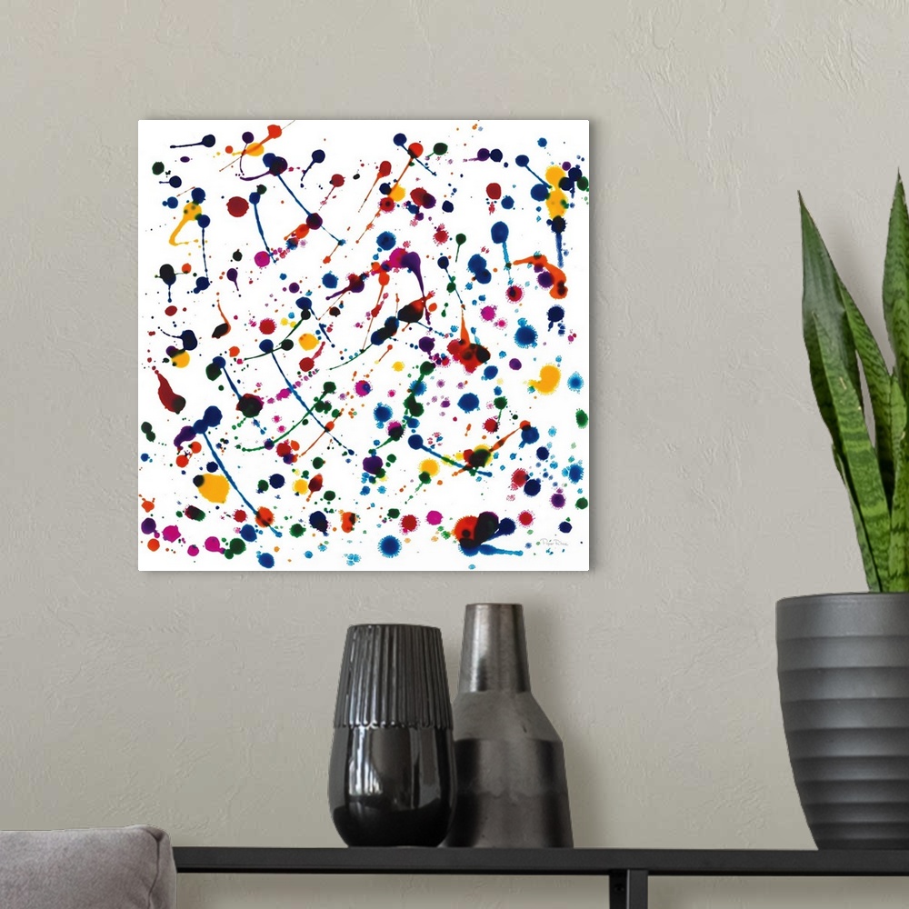 A modern room featuring Square painting created with vibrant paint splatter using every color of the rainbow.