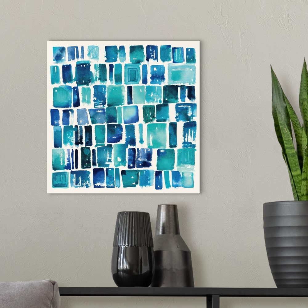 A modern room featuring Home decor artwork of a watercolor geometric shapes in a grid formation.