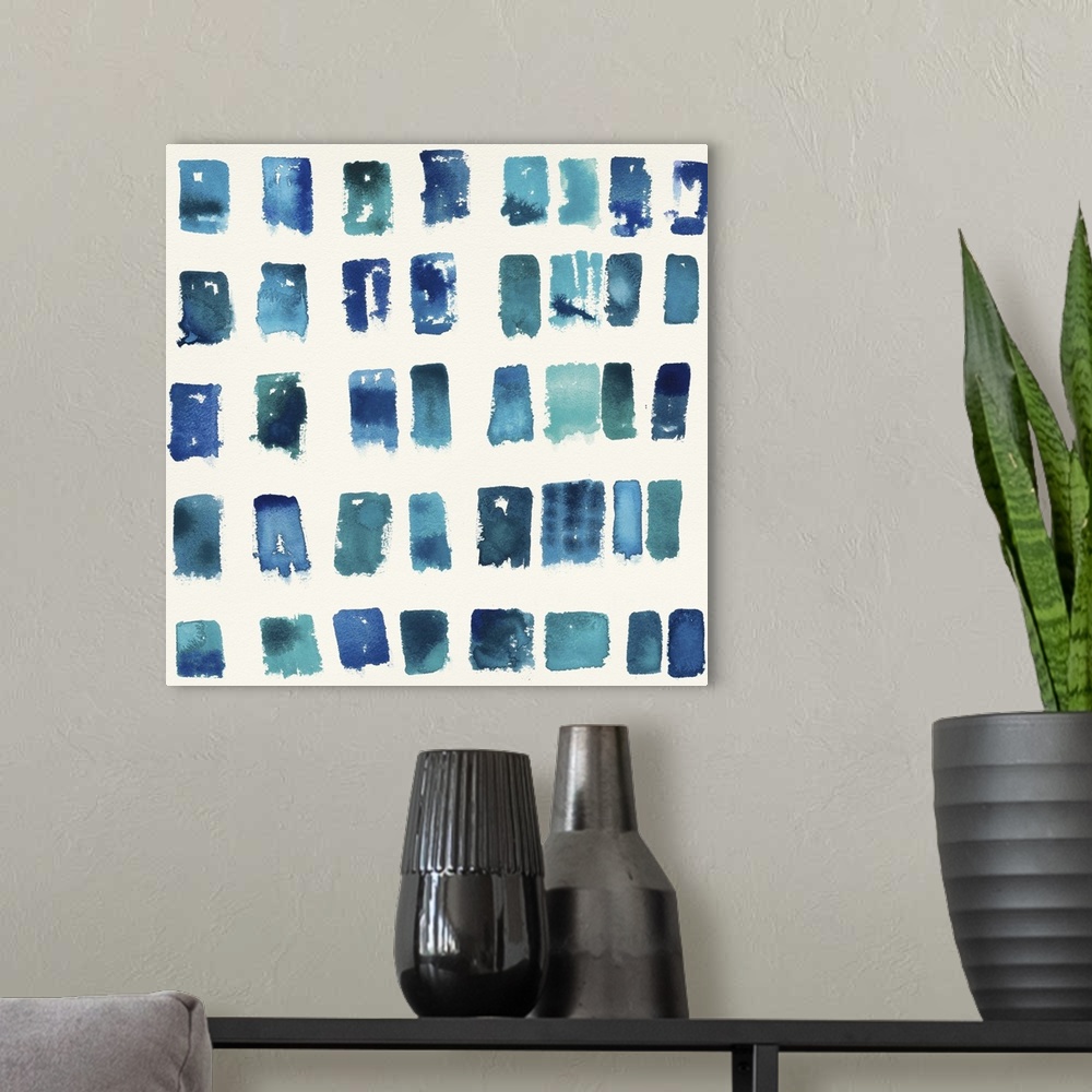 A modern room featuring Home decor artwork of a watercolor geometric shapes in a grid formation.