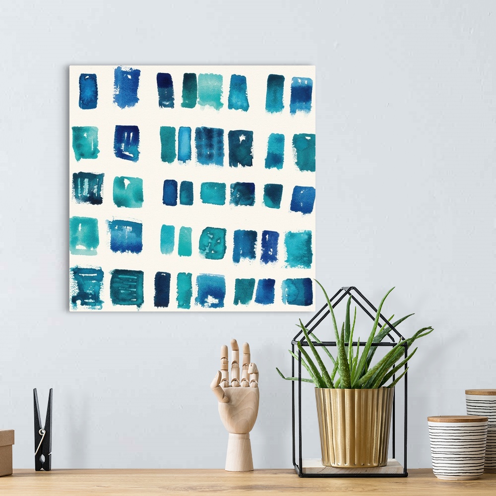 A bohemian room featuring Home decor artwork of a watercolor geometric shapes in a grid formation.