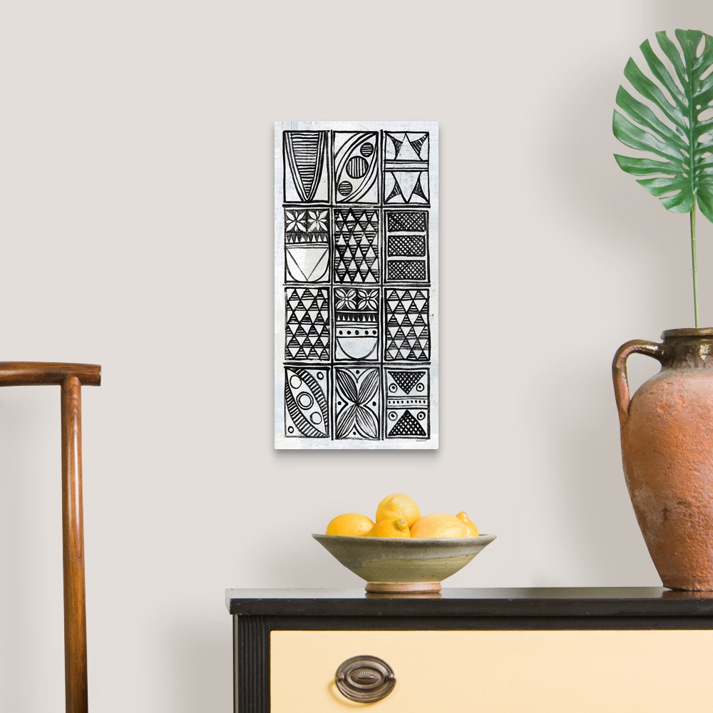 A traditional room featuring Black and white painting with neatly stacked rectangles filled with  different intricate designs.