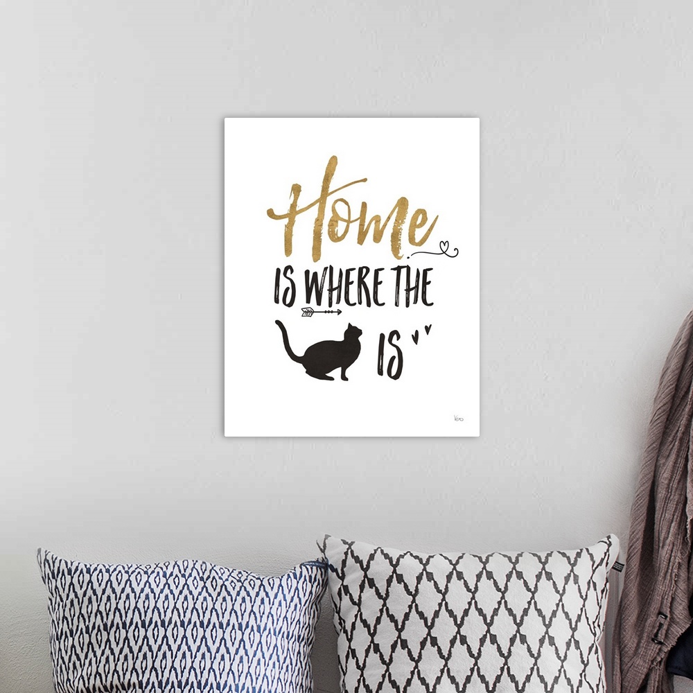 A bohemian room featuring "Home is Where the (cat) is" in black and gold.