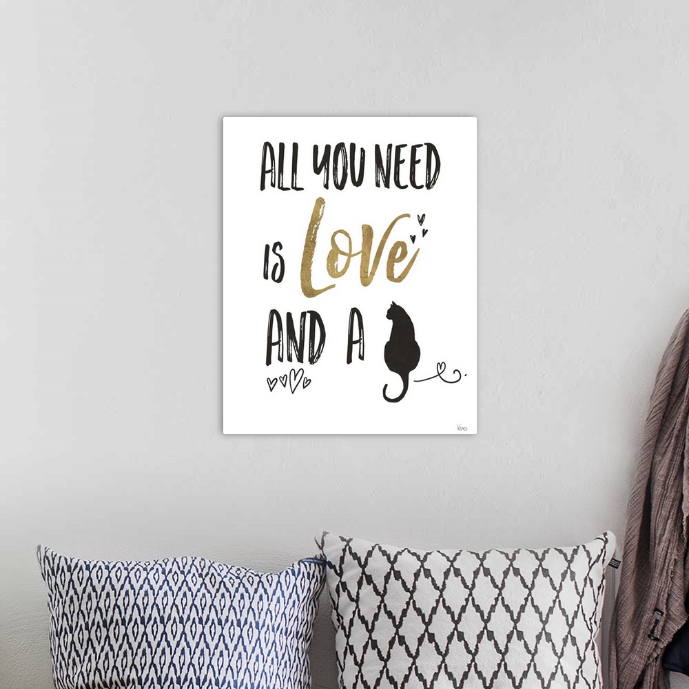 A bohemian room featuring "All You Need is Love and a (cat)" in black and gold.