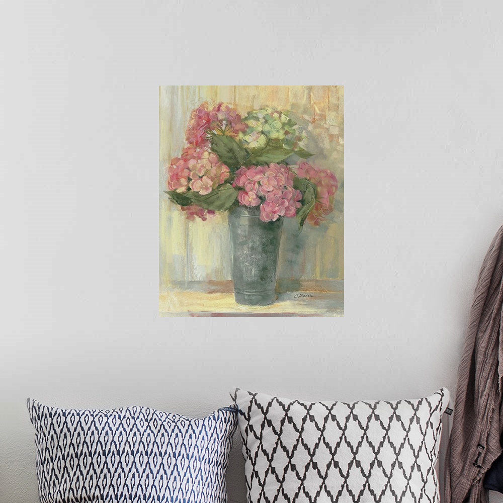 A bohemian room featuring Painting of tall tin vase filled with pastel colored flowers.