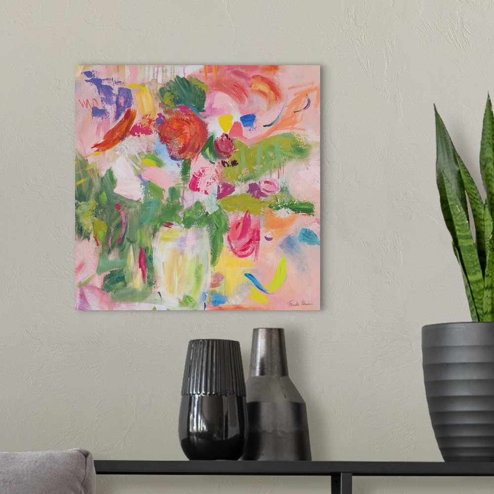 A modern room featuring A square modern painting of bright colorful flowers in shades of pink, in a vase.