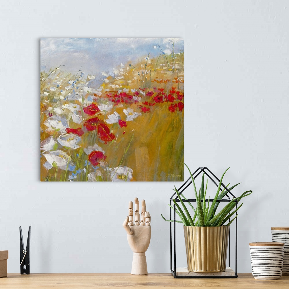 A bohemian room featuring A bright painting in warm colors of red and white flowers in a field under and a blue sky.