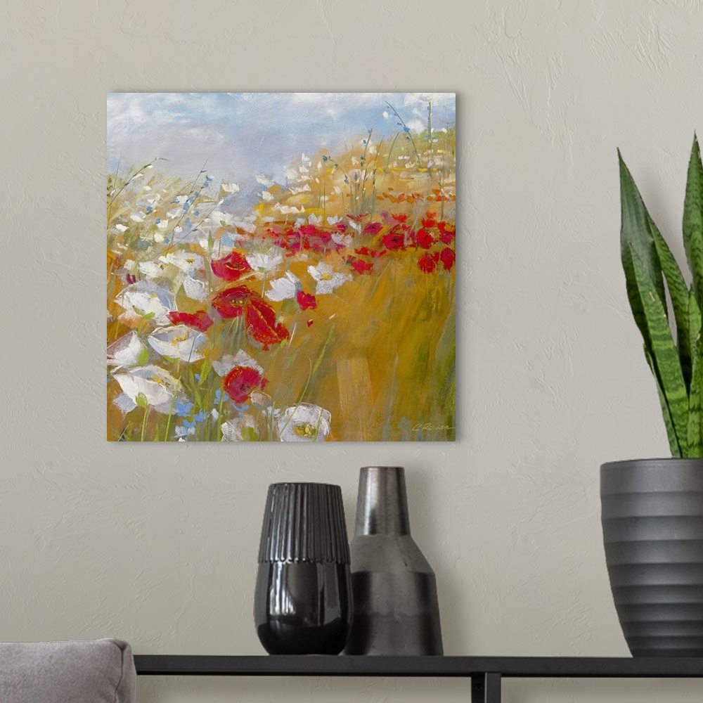 A modern room featuring A bright painting in warm colors of red and white flowers in a field under and a blue sky.