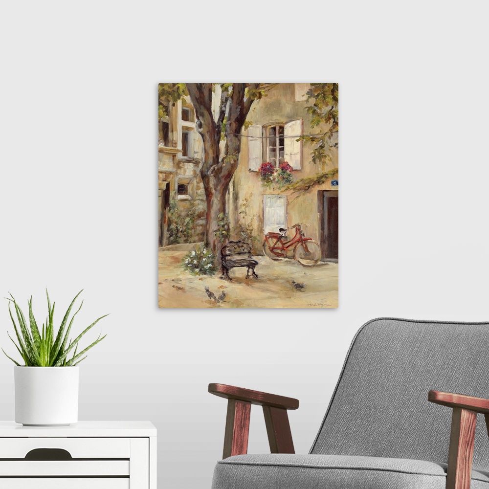 A modern room featuring Painting of building courtyard with huge tree growing in center.  The building is covered with wi...