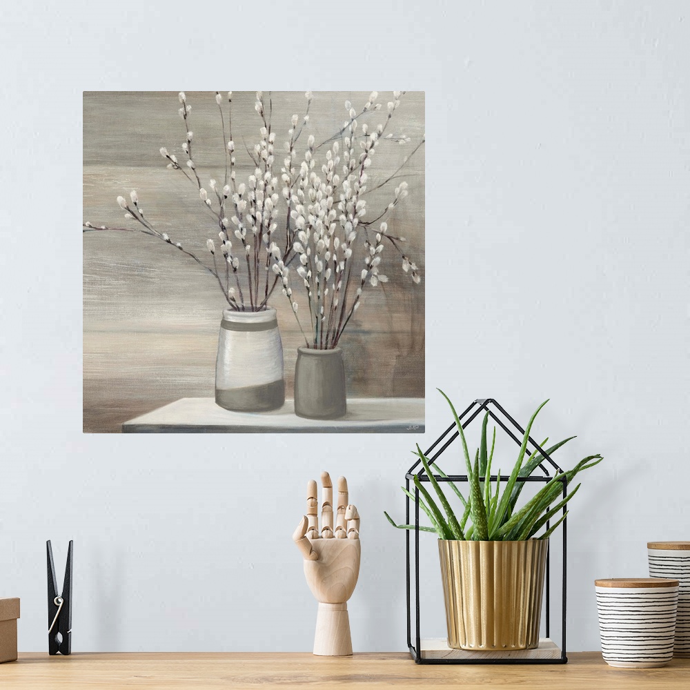A bohemian room featuring Still life painting of pussy willow plants arranged in gray and white vases on a table.