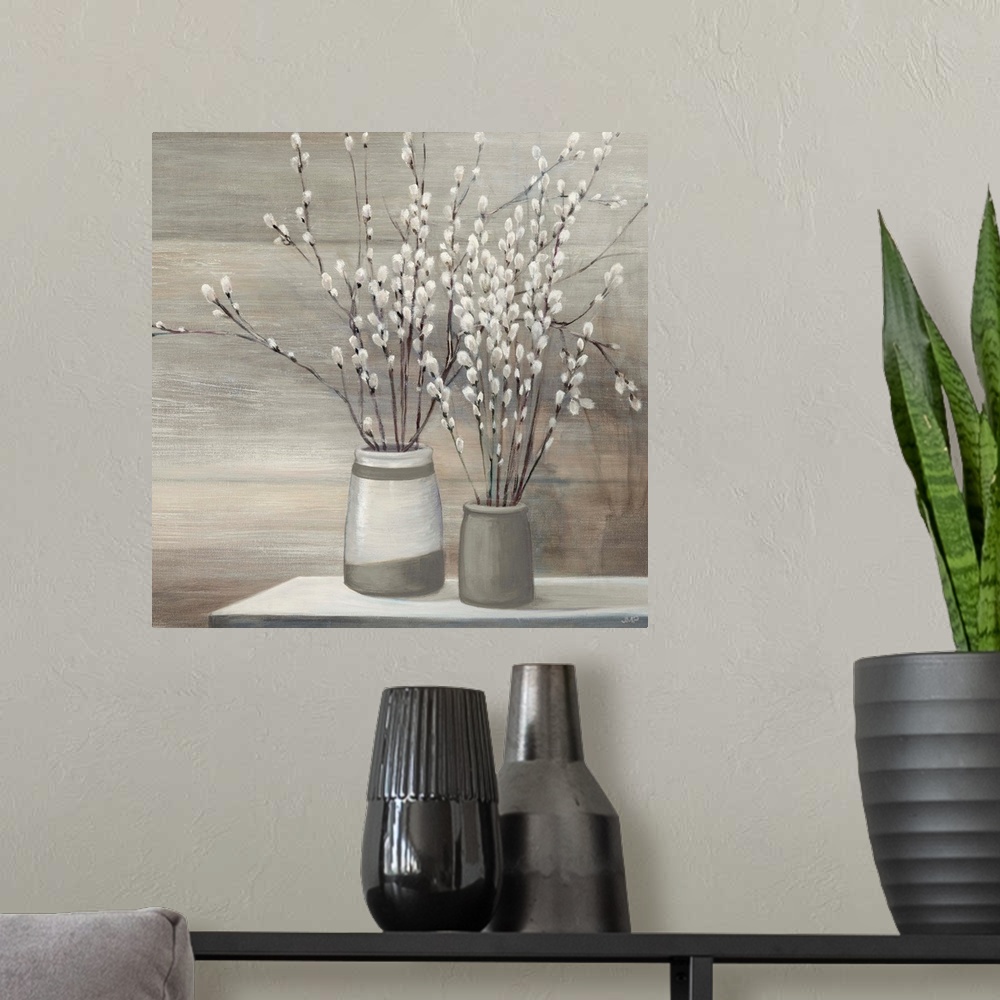 A modern room featuring Still life painting of pussy willow plants arranged in gray and white vases on a table.