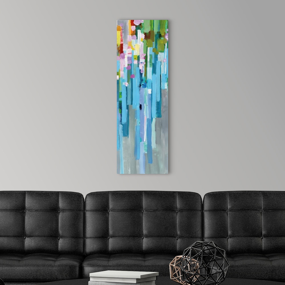 A modern room featuring Tall, rectangular abstract painting with rainbow vertical rectangles stacked together and falling...