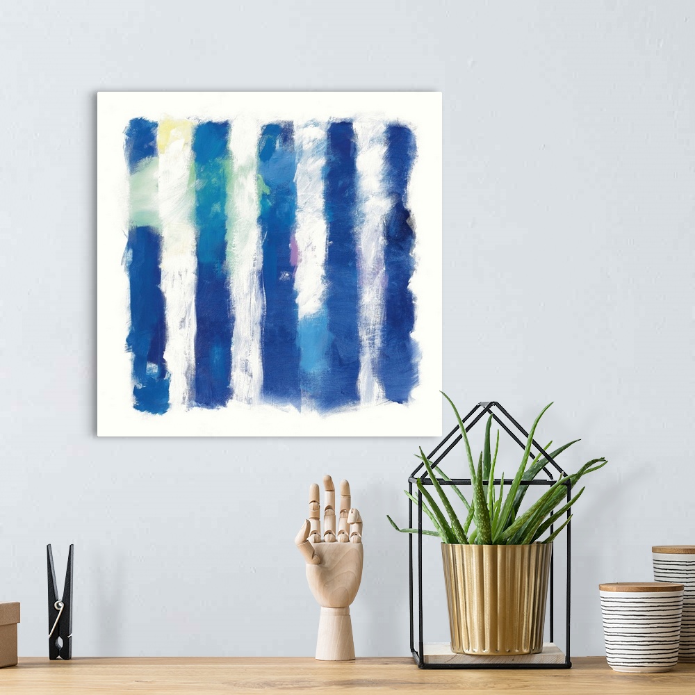 A bohemian room featuring Abstract art of deep blue vertical stripes on white.