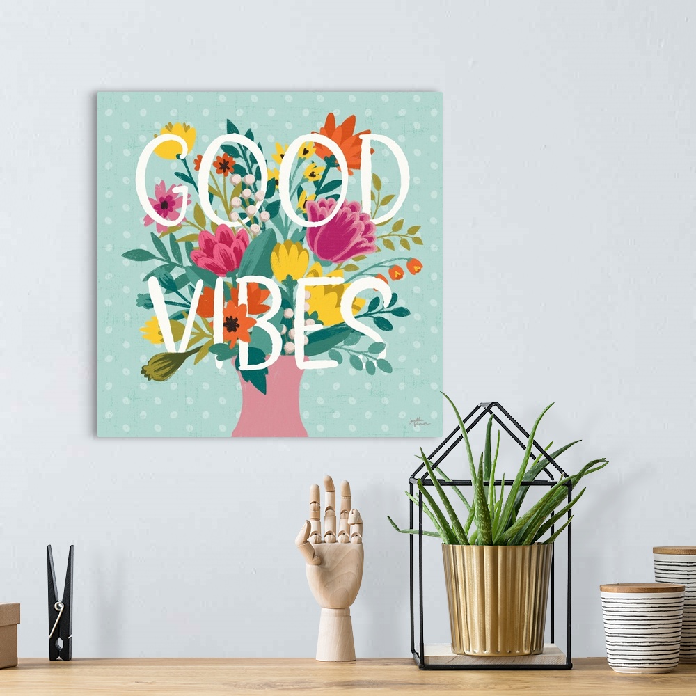 A bohemian room featuring This decorative artwork features the words, 'Good Vibes' over a blue polka dot background with sp...