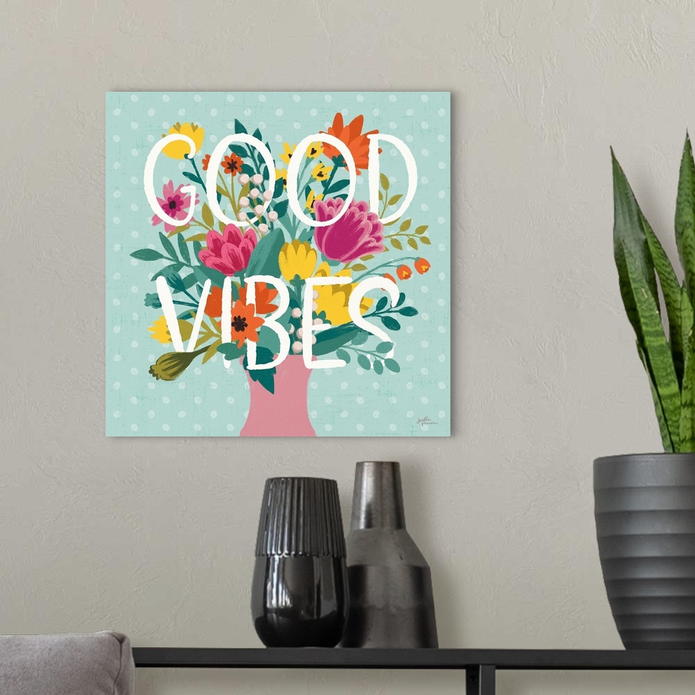 A modern room featuring This decorative artwork features the words, 'Good Vibes' over a blue polka dot background with sp...