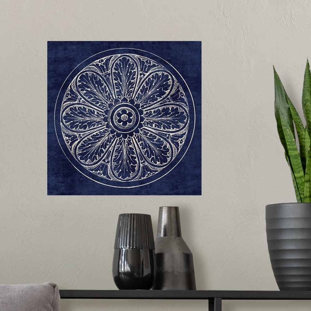 A modern room featuring Contemporary artwork of a vintage stylized rosette in dark blue.