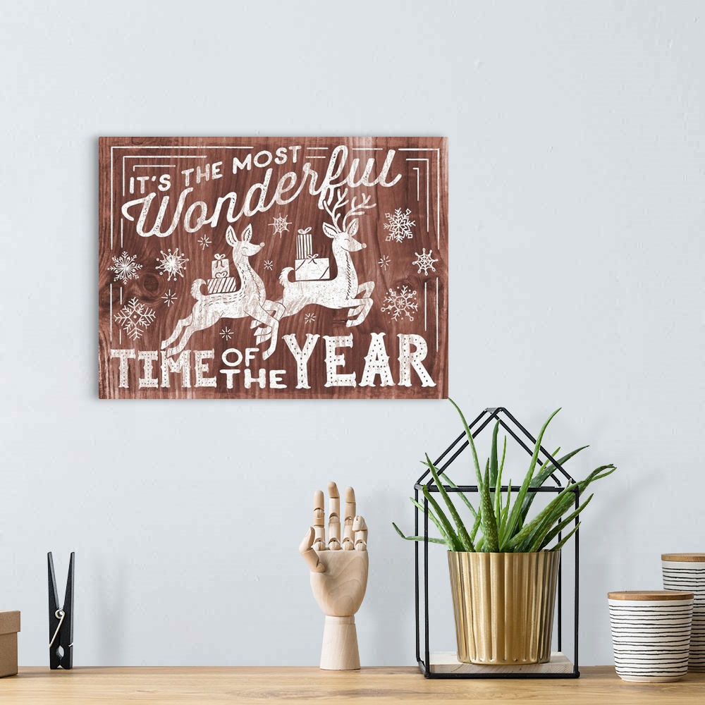 A bohemian room featuring "It's the Most Wonderful Time of the Year" decorative holiday art on a red wood background.