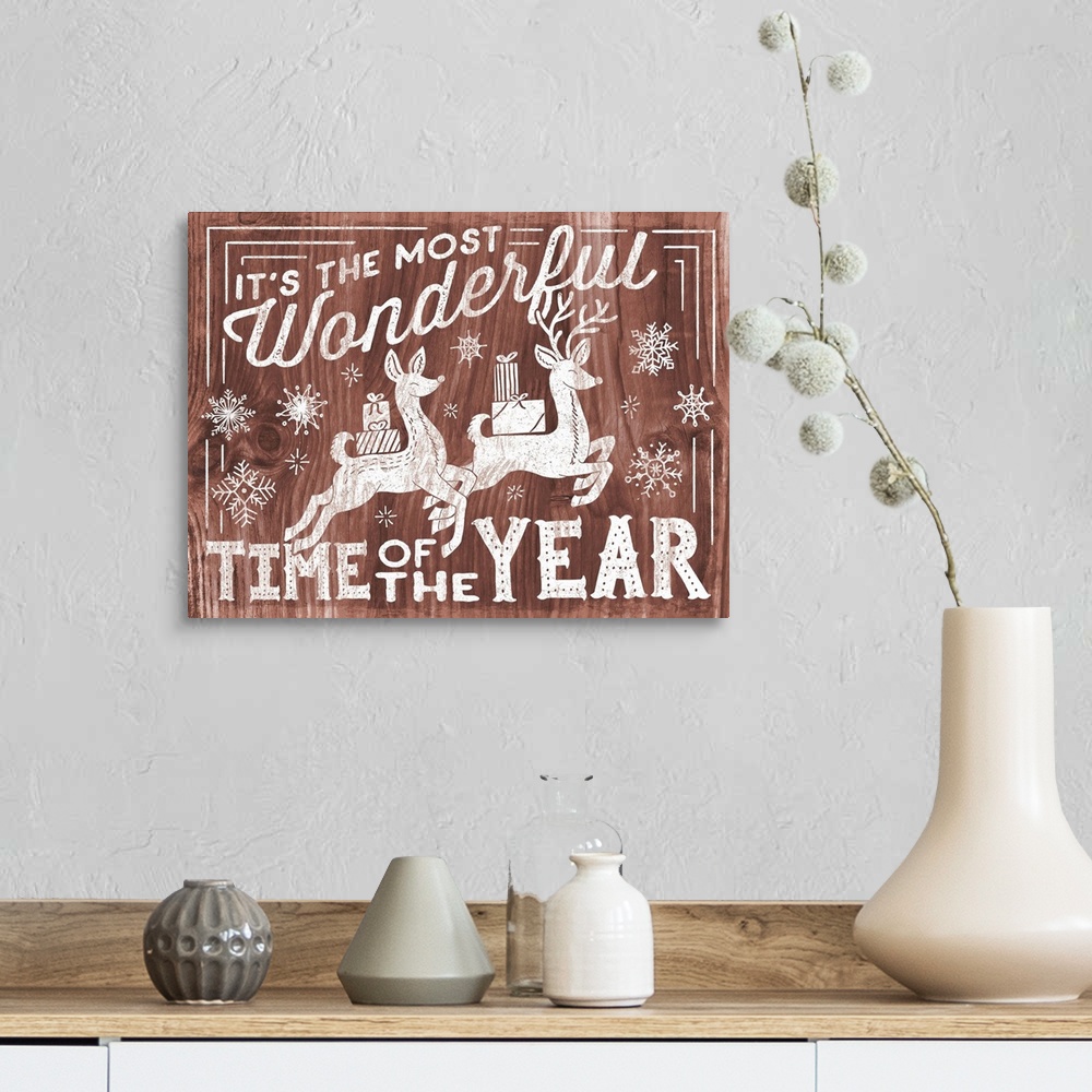 A farmhouse room featuring "It's the Most Wonderful Time of the Year" decorative holiday art on a red wood background.