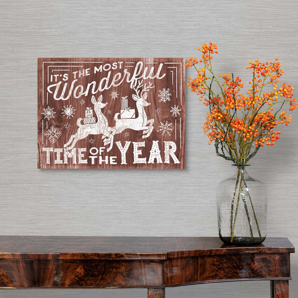 A traditional room featuring "It's the Most Wonderful Time of the Year" decorative holiday art on a red wood background.