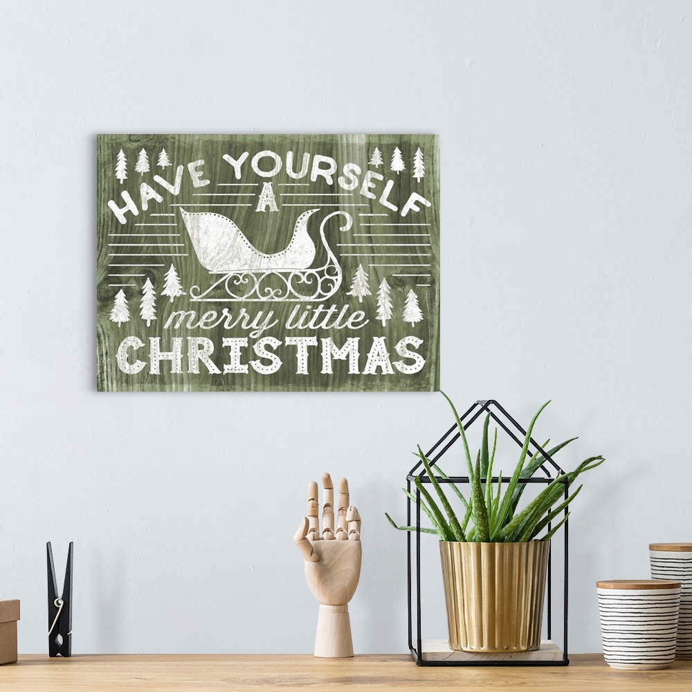 A bohemian room featuring "Have Yourself a Merry Little Christmas" decorative holiday art on a green wood background.