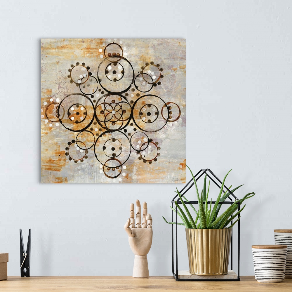 A bohemian room featuring Square abstract painting of a symmetric mandala pattern created out of circles on a textured gray...