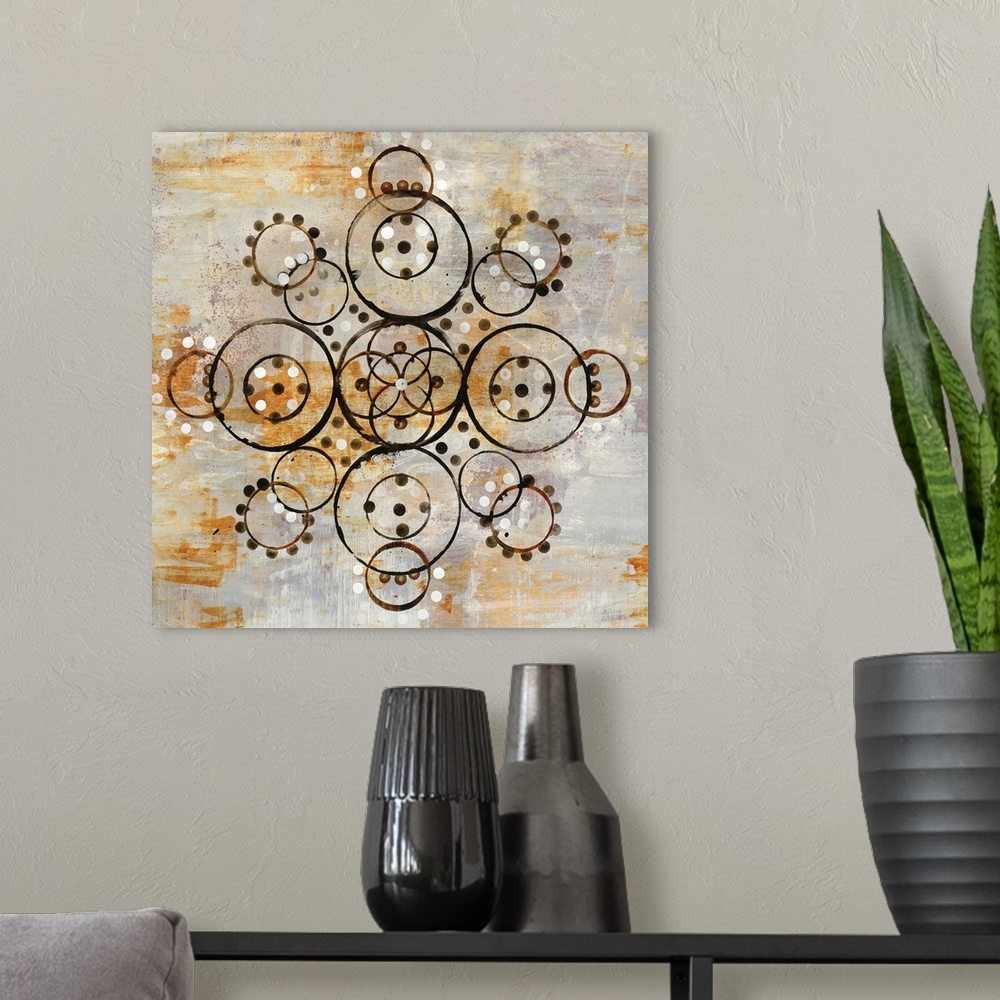 A modern room featuring Square abstract painting of a symmetric mandala pattern created out of circles on a textured gray...