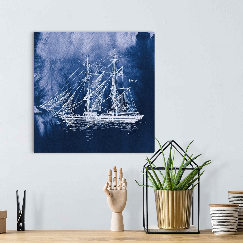 A bohemian room featuring Square art with a white silhouette of a sailboat on an indigo watercolor background and "Brig" wr...