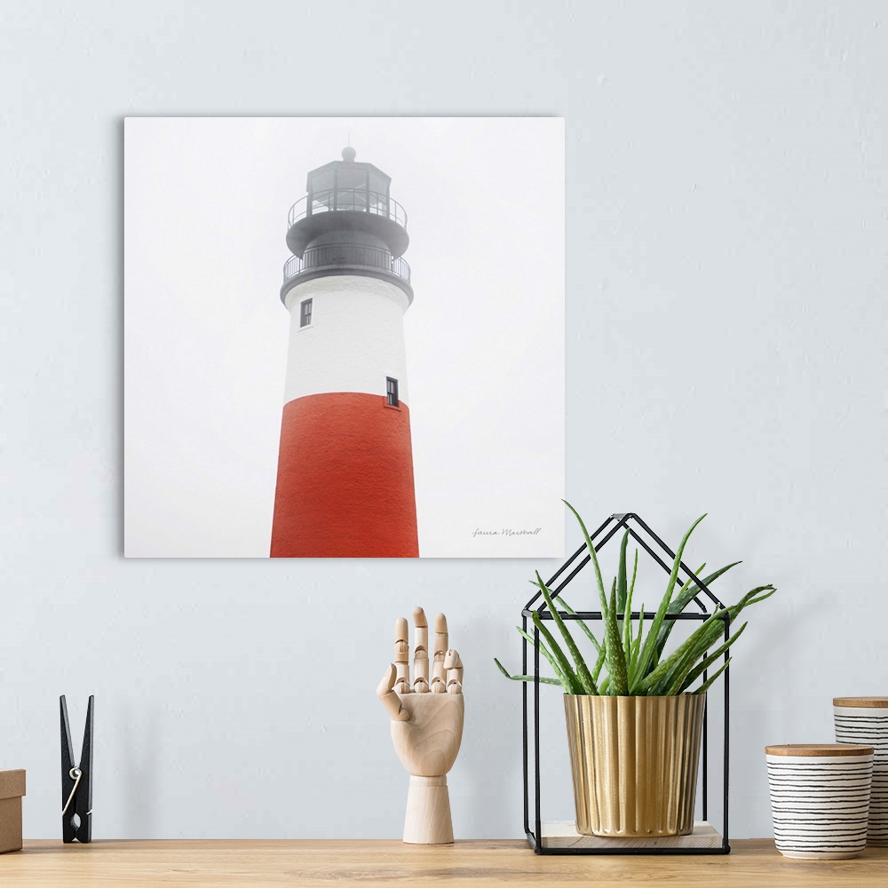 A bohemian room featuring A square photograph of the Sankaty Head Lighthouse in Nantucket Island, Massachusetts, blanketed ...