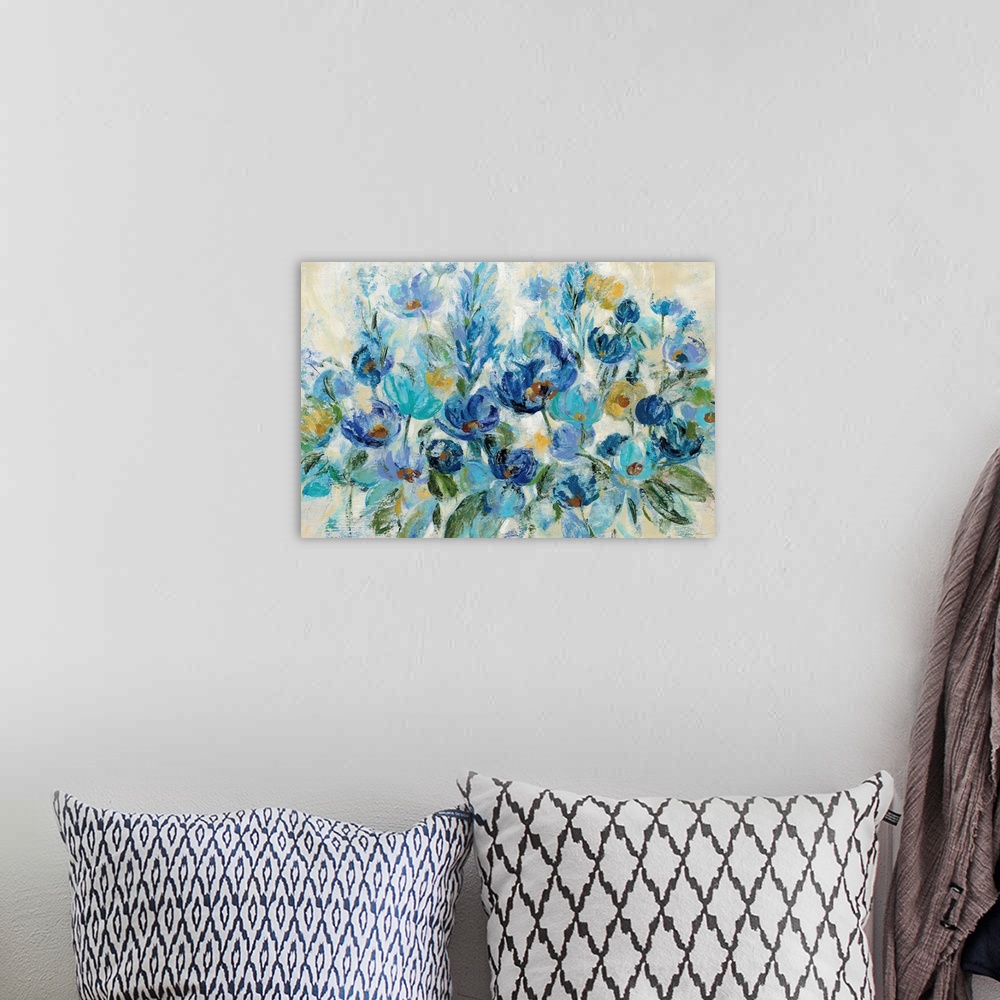 A bohemian room featuring Large painting of a bunch of flowers in shades of blue with some gold on a neutral colored backgr...