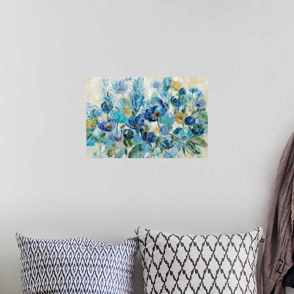 A bohemian room featuring Large painting of a bunch of flowers in shades of blue with some gold on a neutral colored backgr...