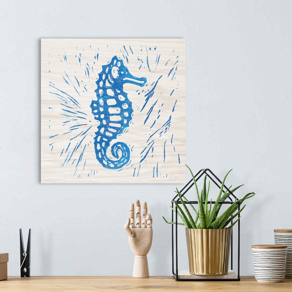 A bohemian room featuring Blue woodcut-style seahorse print on wood.