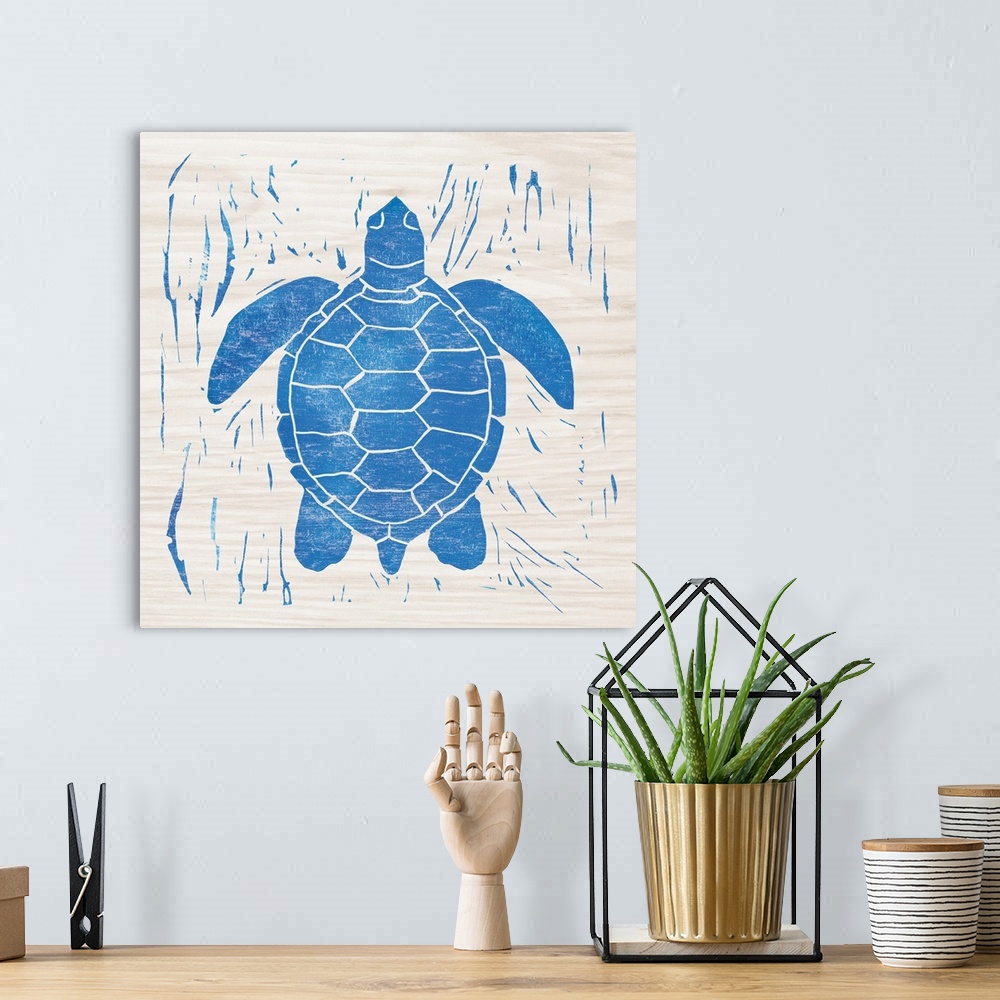 A bohemian room featuring Blue woodcut-style sea turtle print on wood.