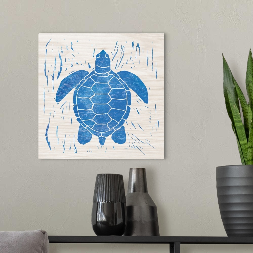 A modern room featuring Blue woodcut-style sea turtle print on wood.
