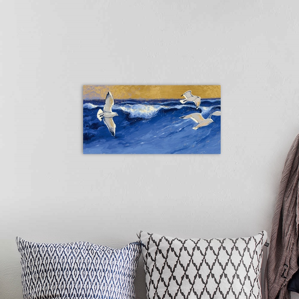 A bohemian room featuring A contemporary painting of seagulls in flight over a choppy blue sea.