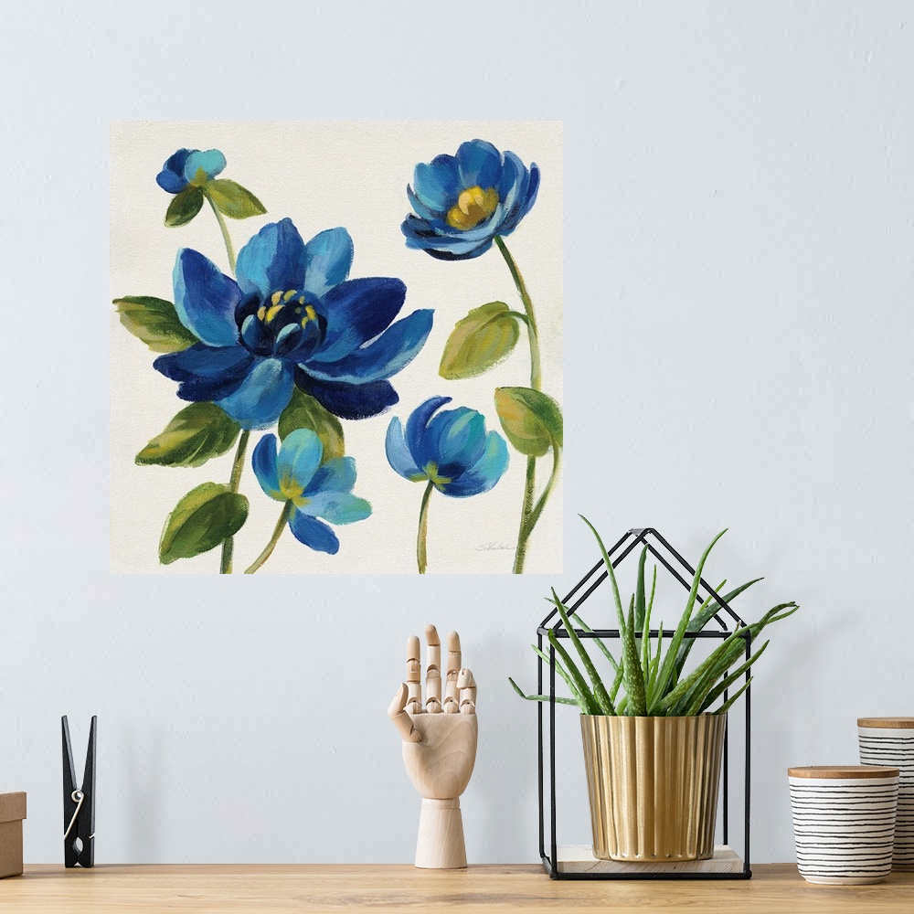 A bohemian room featuring Square painting of blue flowers on an off white background.