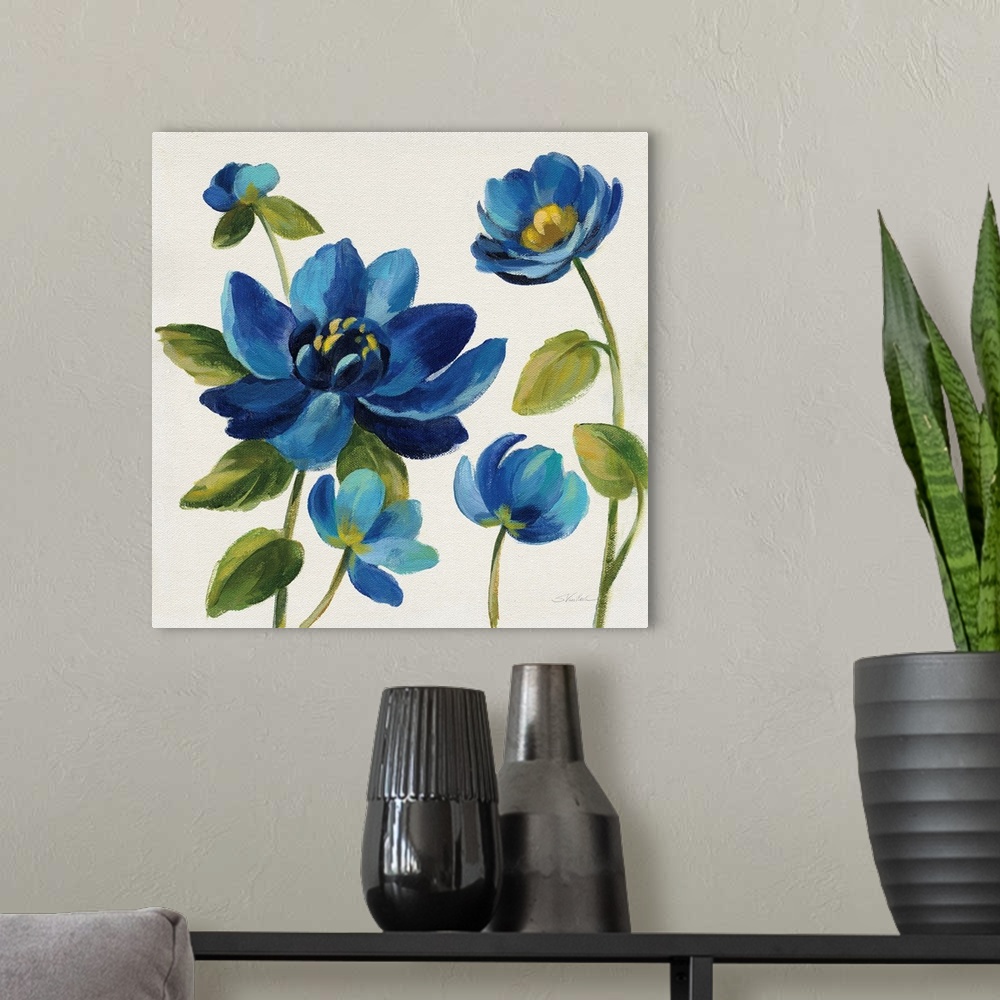 A modern room featuring Square painting of blue flowers on an off white background.