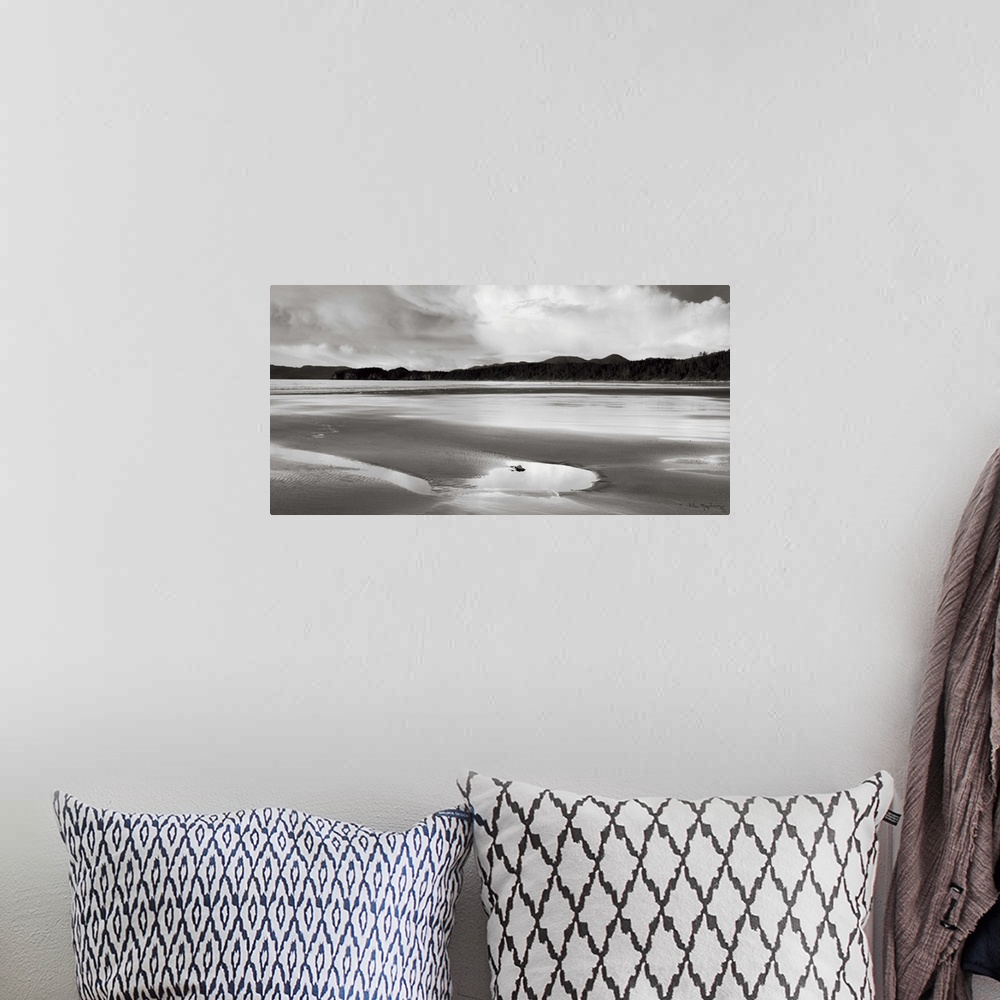 A bohemian room featuring A black and white photograph of and idyllic beach scene.