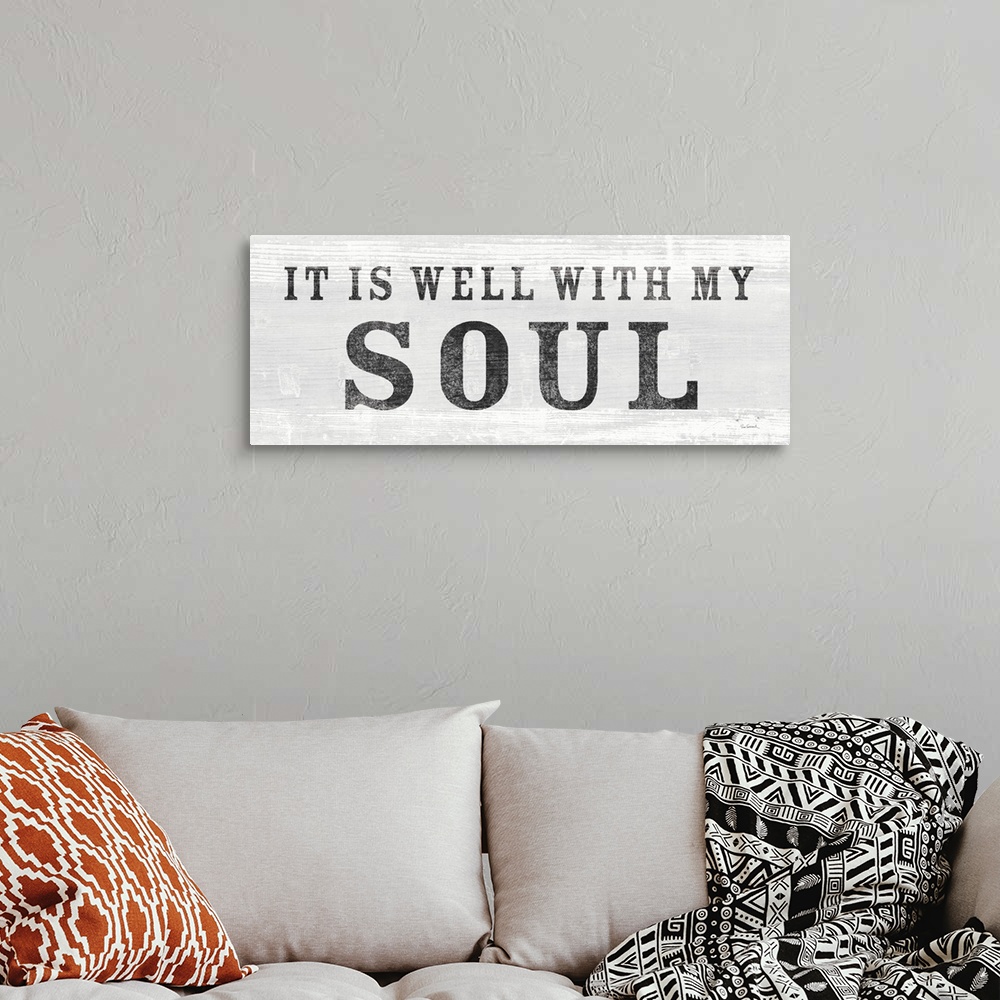 A bohemian room featuring "It Is Well With My Soul" against a light gray shiplap background.