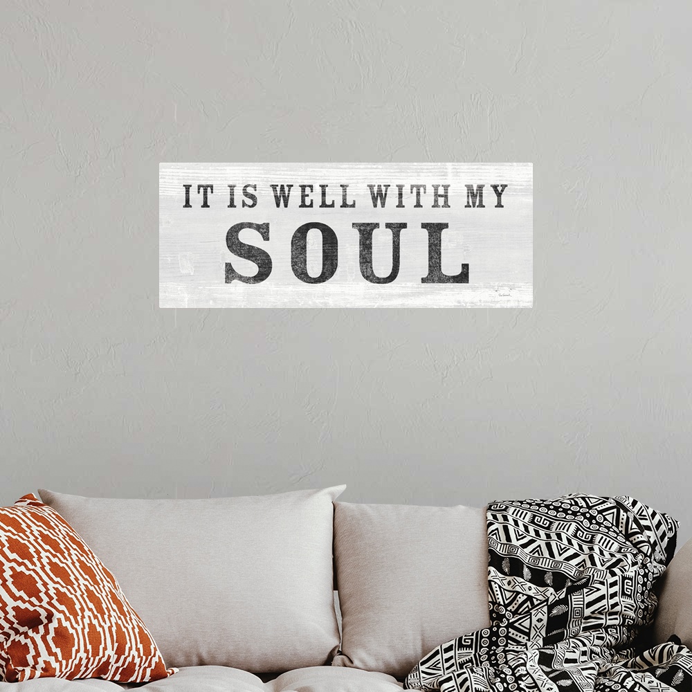 A bohemian room featuring "It Is Well With My Soul" against a light gray shiplap background.