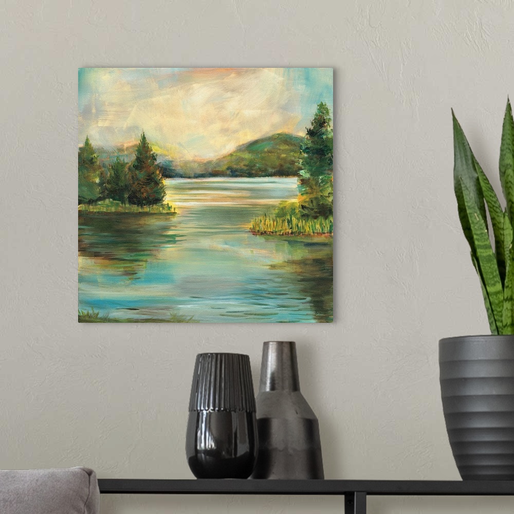 A modern room featuring Contemporary landscape painting of a lake at sunset with rolling hills in the distance.