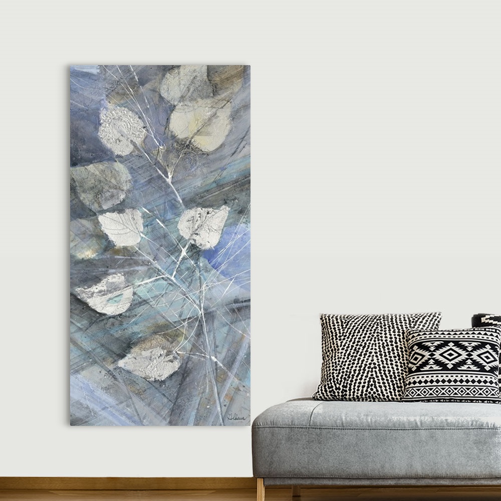 A bohemian room featuring Contemporary artwork of silver leaves against a blue toned background.