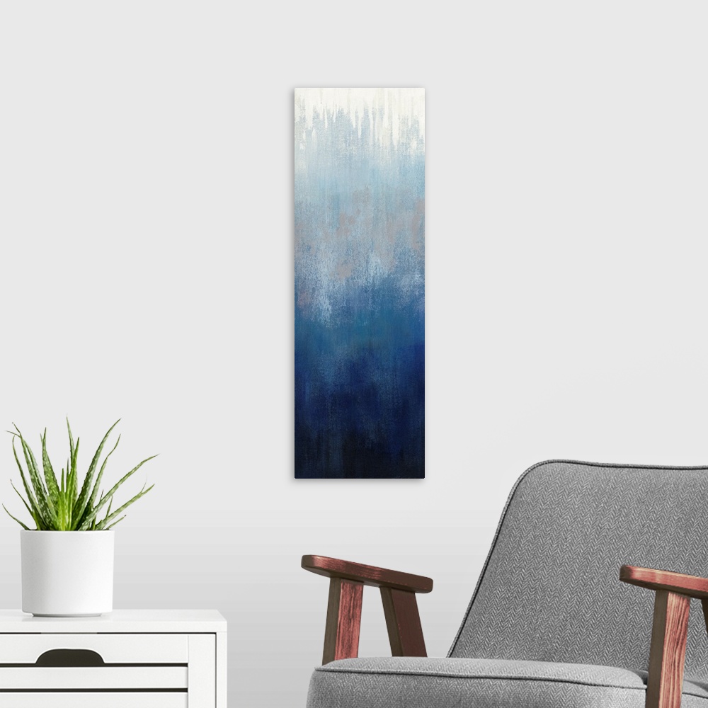 A modern room featuring Abstract panel painting in shades of gray and blue getting darker towards the bottom.