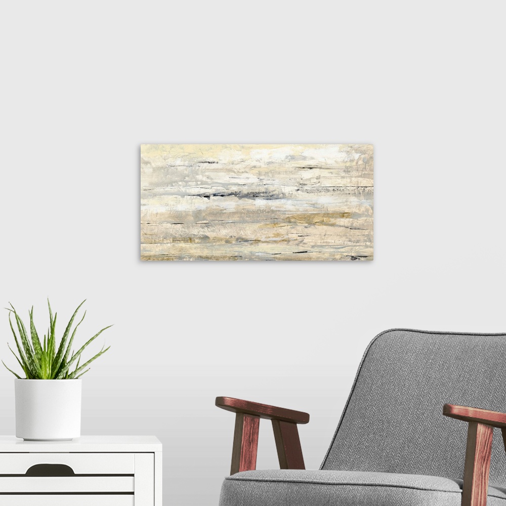 A modern room featuring Abstract painting with neutral colors running horizontally across and pops of gold.