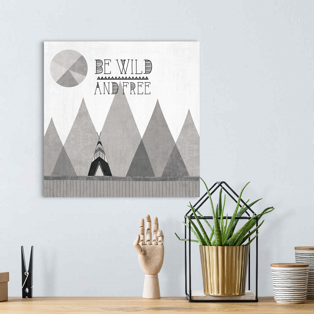 A bohemian room featuring A square decorative design of a tent along mountains with the text 'Be Wild and Free', all in gre...