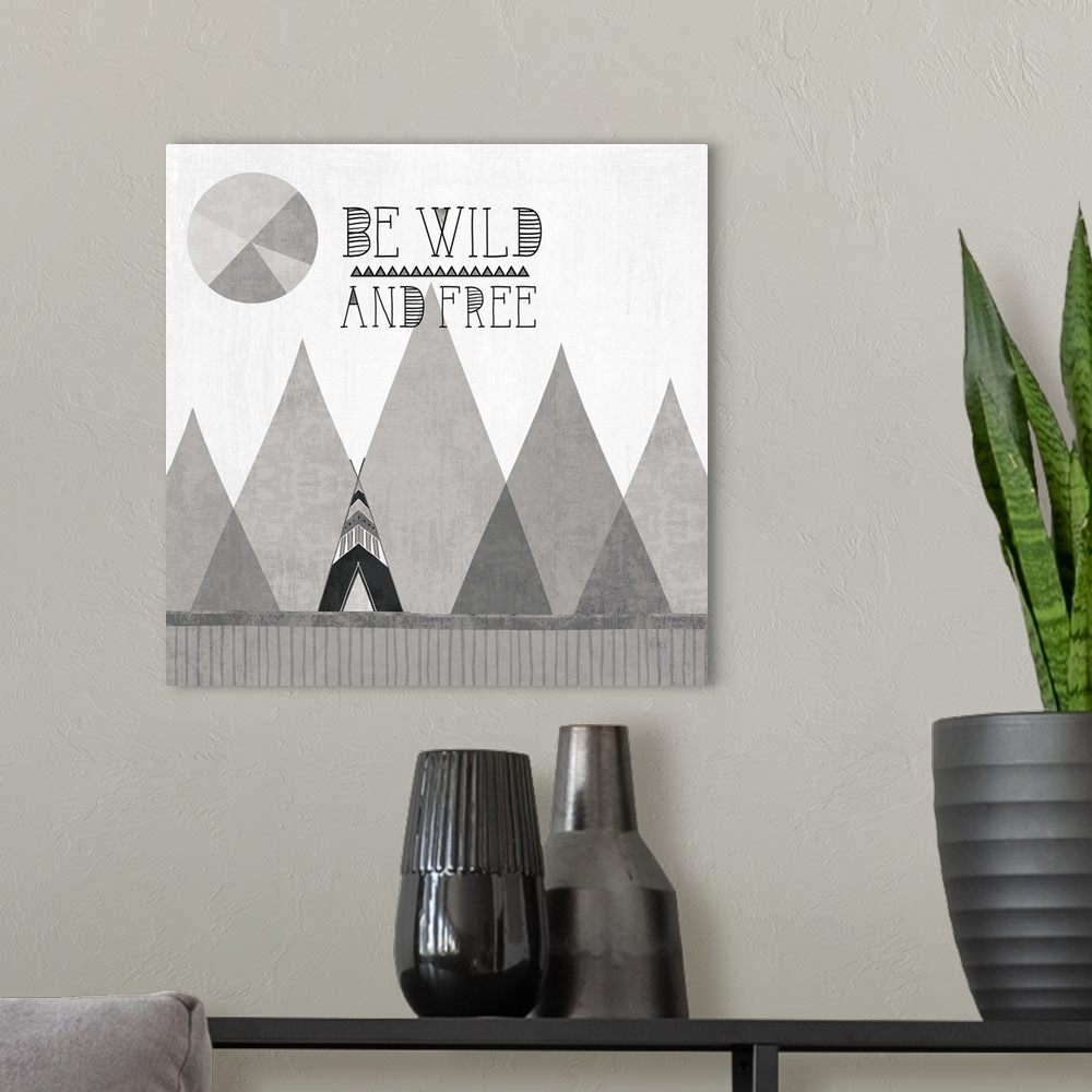 A modern room featuring A square decorative design of a tent along mountains with the text 'Be Wild and Free', all in gre...