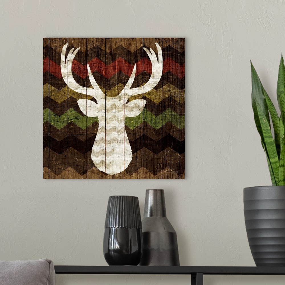 A modern room featuring Artwork of a deer head silhouette on a wooden panel, decorated with Southwestern shapes.