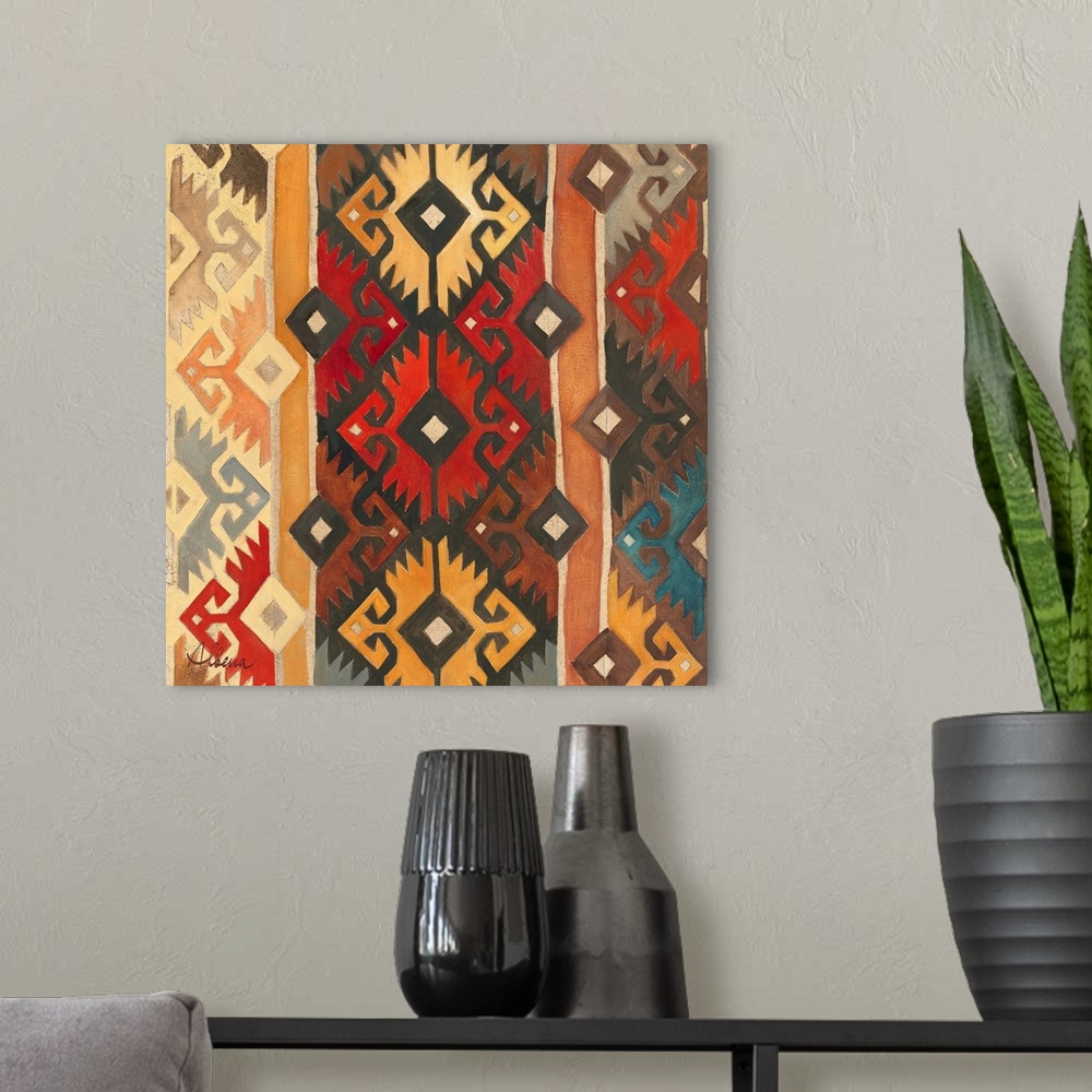 A modern room featuring Contemporary artwork of a geometric tribal pattern in earth tones.